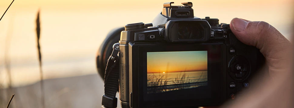 Sonnenuntergang wird fotografiert mit einer Spiegelreflexkamera
